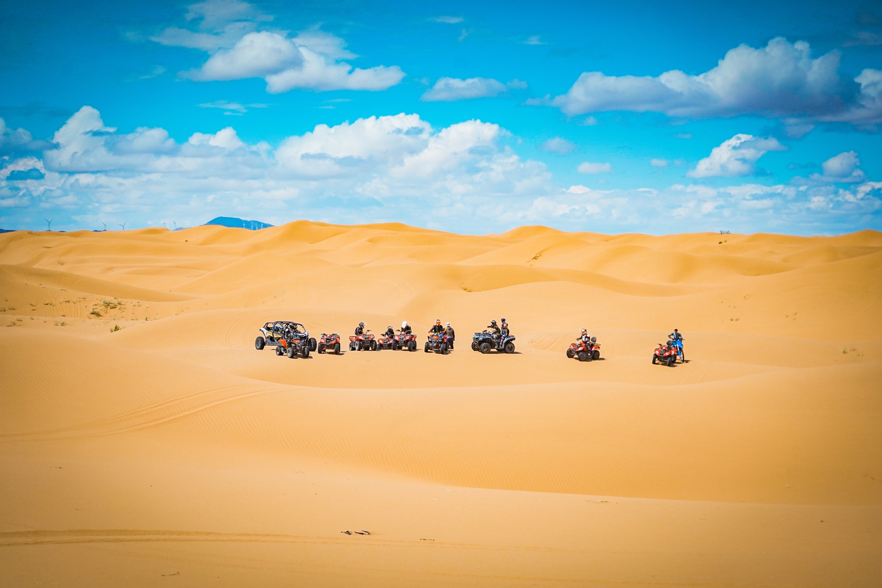 Little Knights riders and guides crossing a wide desert landscape during a guided educational journey